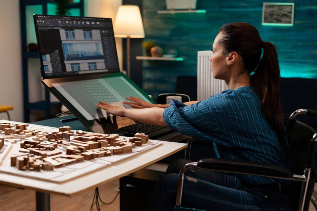 woman in wheelchair working at accessible desk